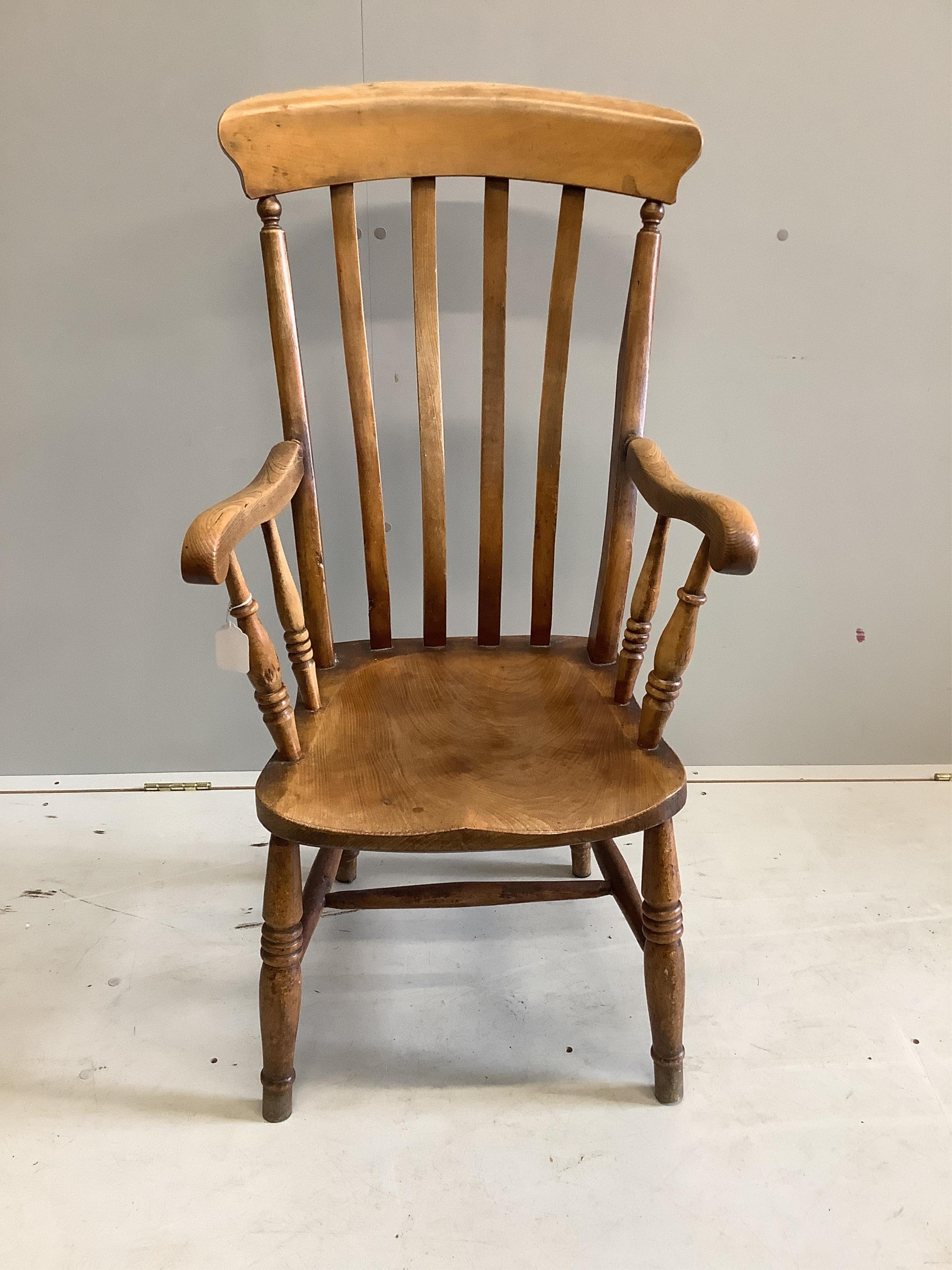 A Victorian elm and beech Windsor lathe back armchair, width 54cm, depth 44cm, height 106cm. Condition - fair